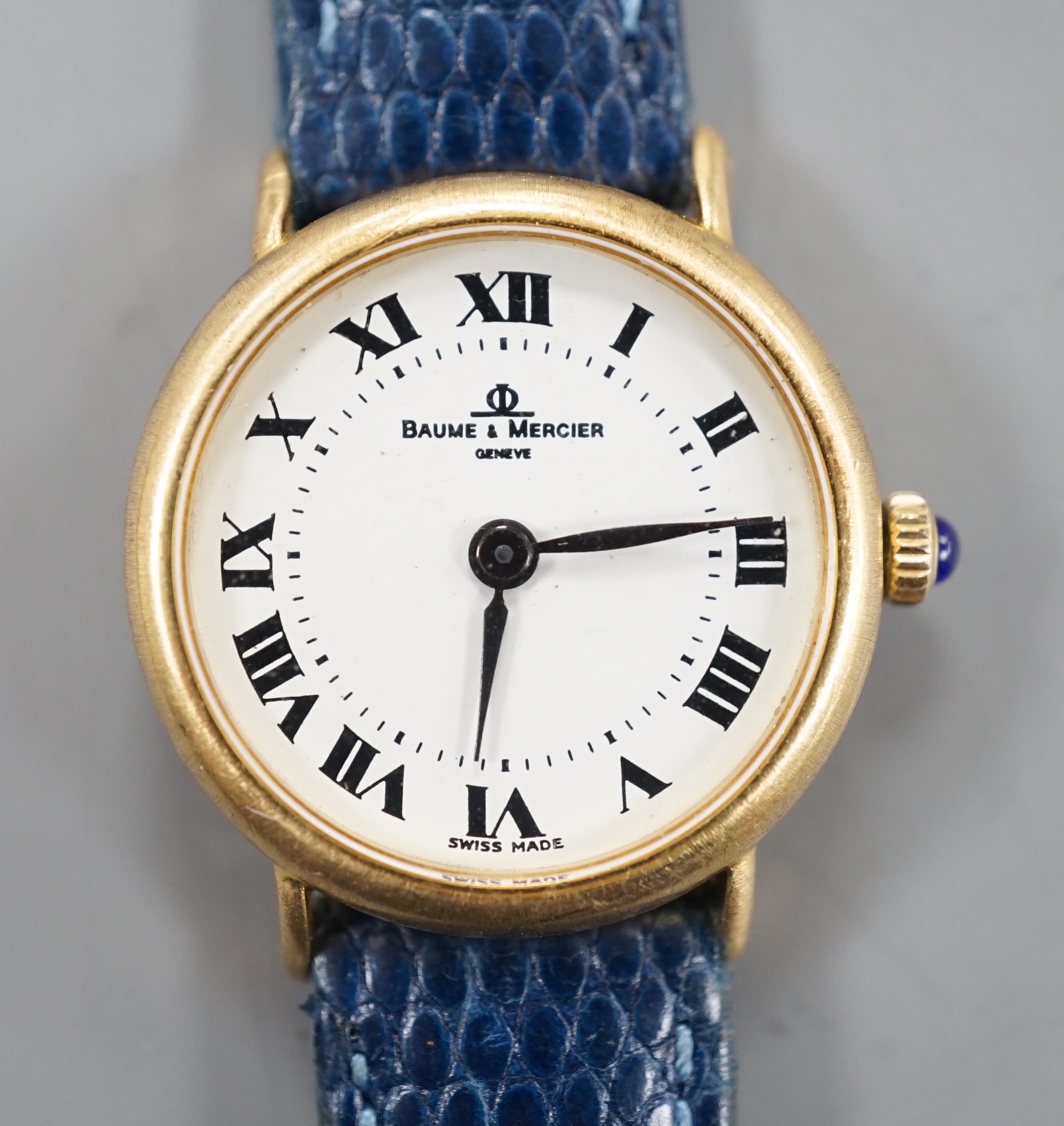 A lady's modern 18k Baume & Mercier manual wind wrist watch, with Roman dial, on associated leather strap, case diameter 24mm.